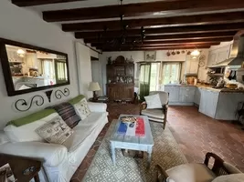 living room with corner kitchen and corner dining room