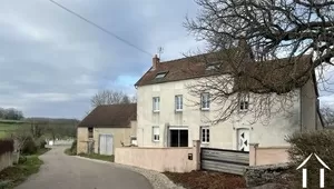 Tall house with barns and garden