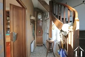 Entrance with toilet under the stairs